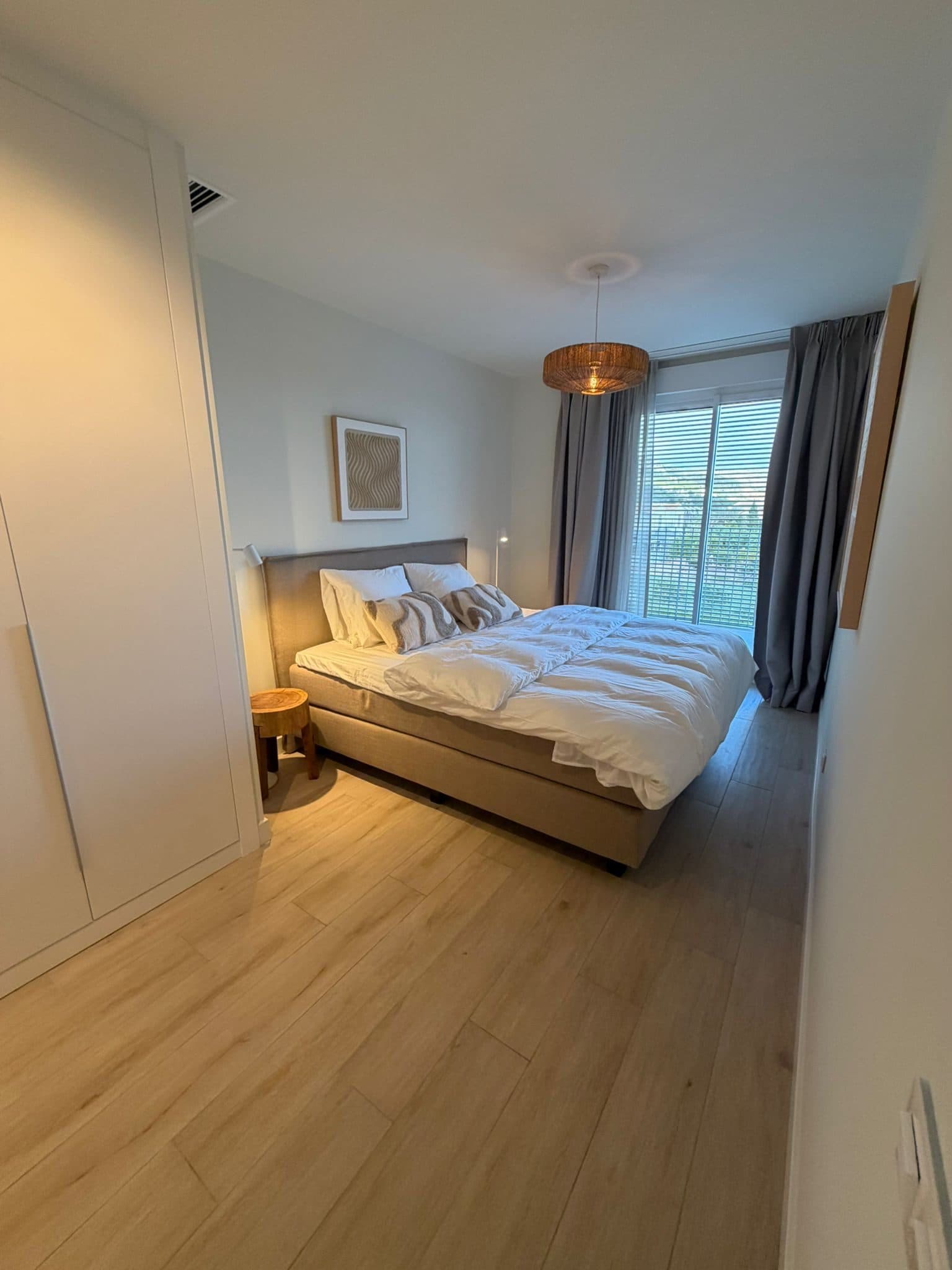 Master bedroom with king-size bed and balcony
