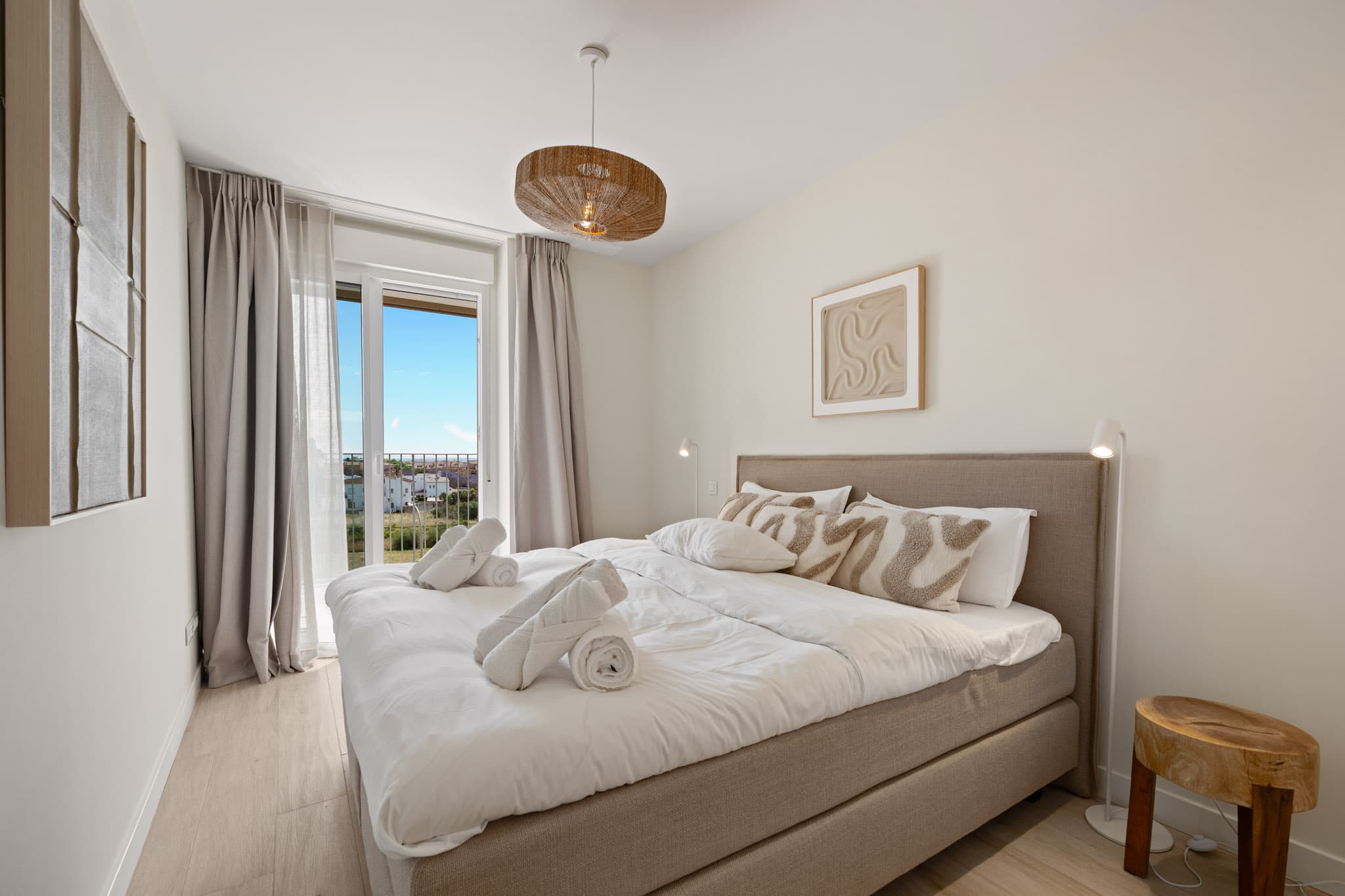 Master bedroom with king-size bed and balcony